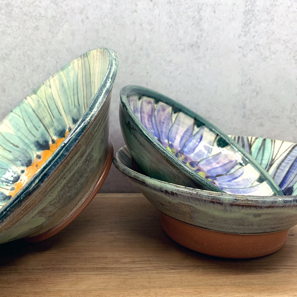 Handmade ceramic bowls with interior flower design by Molly Lithgo. Made in North Carolina.