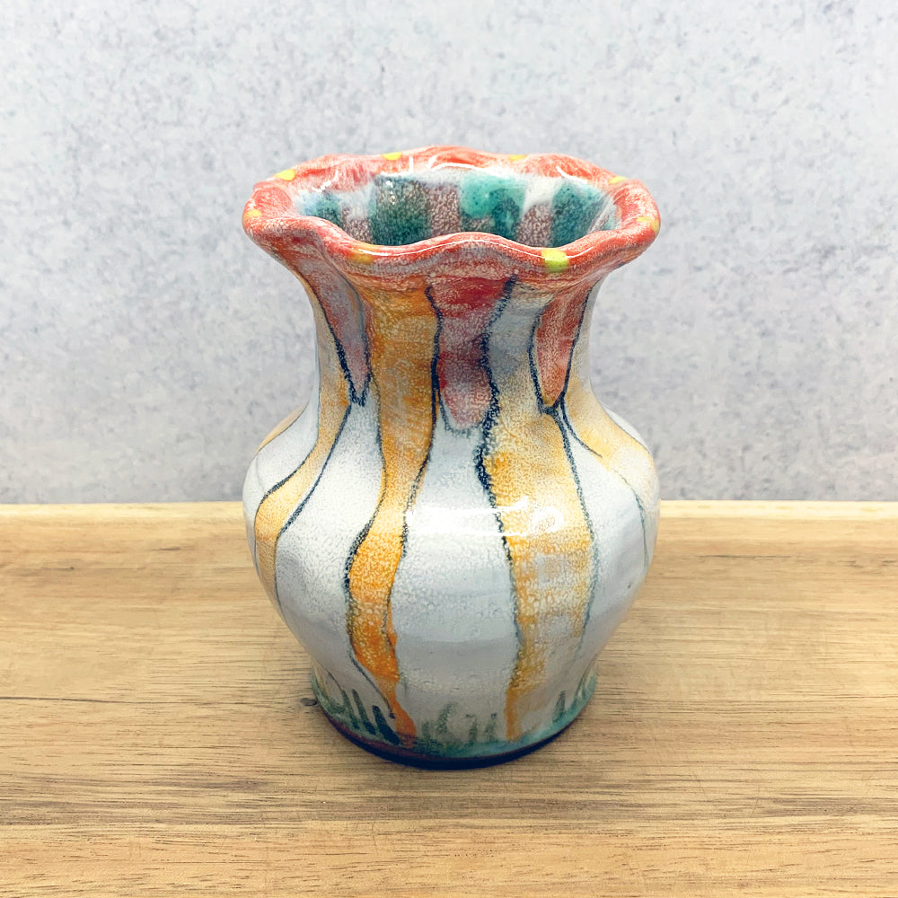 Small, handmade ceramic flower vase by Molly Lithgo. Fluted with colorful decoration. Made in North Carolina.