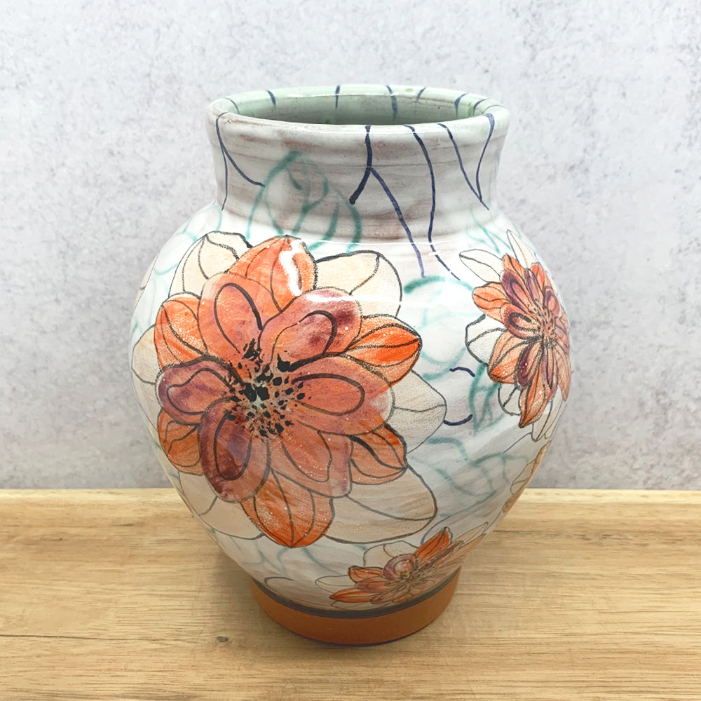 Handmade ceramic vase with orange flower decoration by Molly Lithgo. Made in NC.