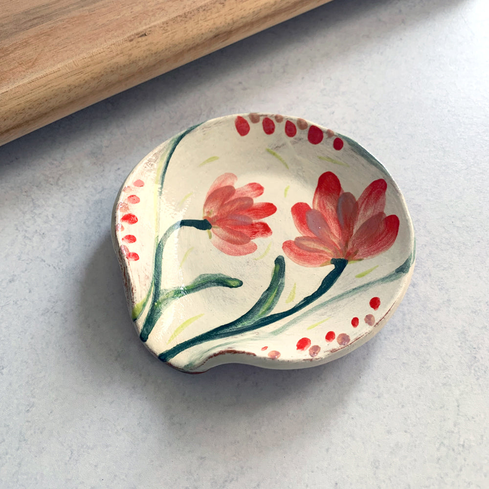 Handmade ceramic spoon rest by Molly Lithgo, decorated with red flowers. Made in North Carolina.