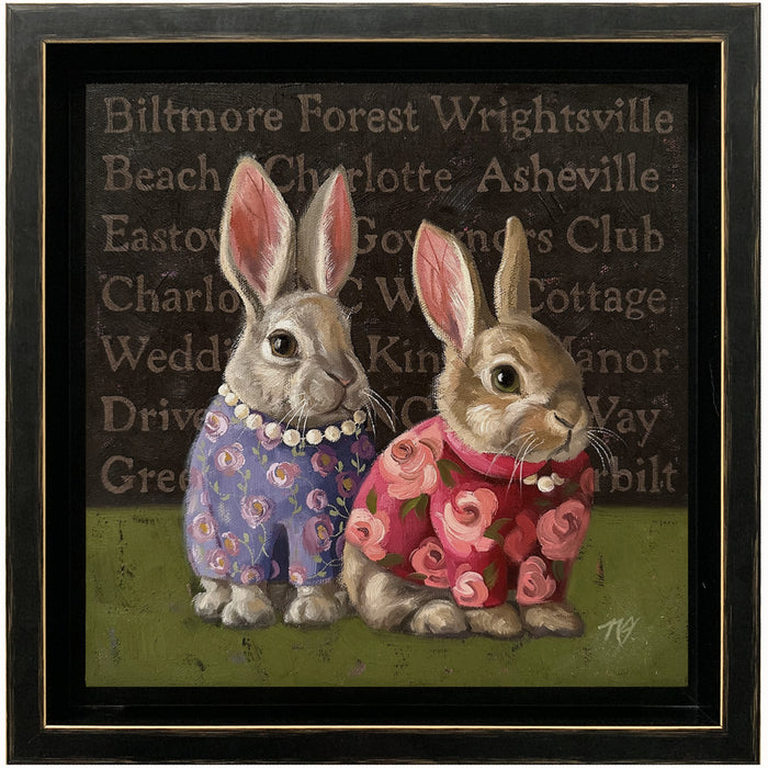 "Southern Sisters" posh rabbit painting by Ninalee Irani. Two rabbits wearing floral blouses and pearls, the names of North Carolina cities and landmarks behind them.