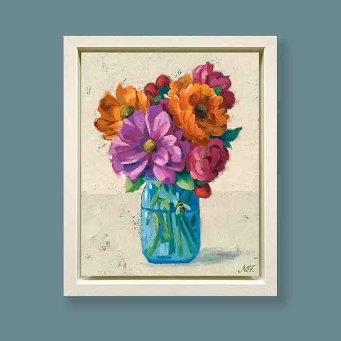 Summer in a Jar, framed oil painting of colorful flowers in a blue jar on a textured background. Artwork by Ninalee Irani displayed on blue wall.