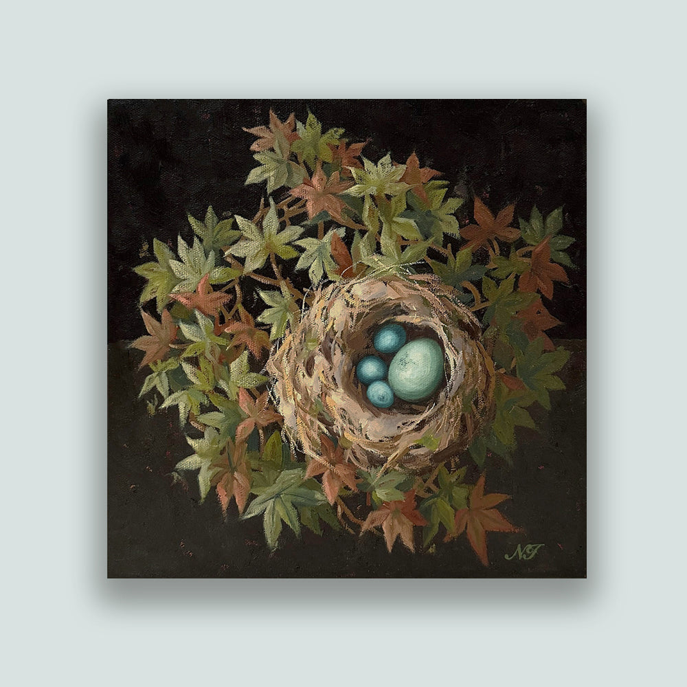 "The Four of Us", 10 x 10" oil painting by Ninalee Irani. A nest with four blue eggs is nestled among green and rust colored foliage, with a dark background. Artwork shown on pale blue wall. 