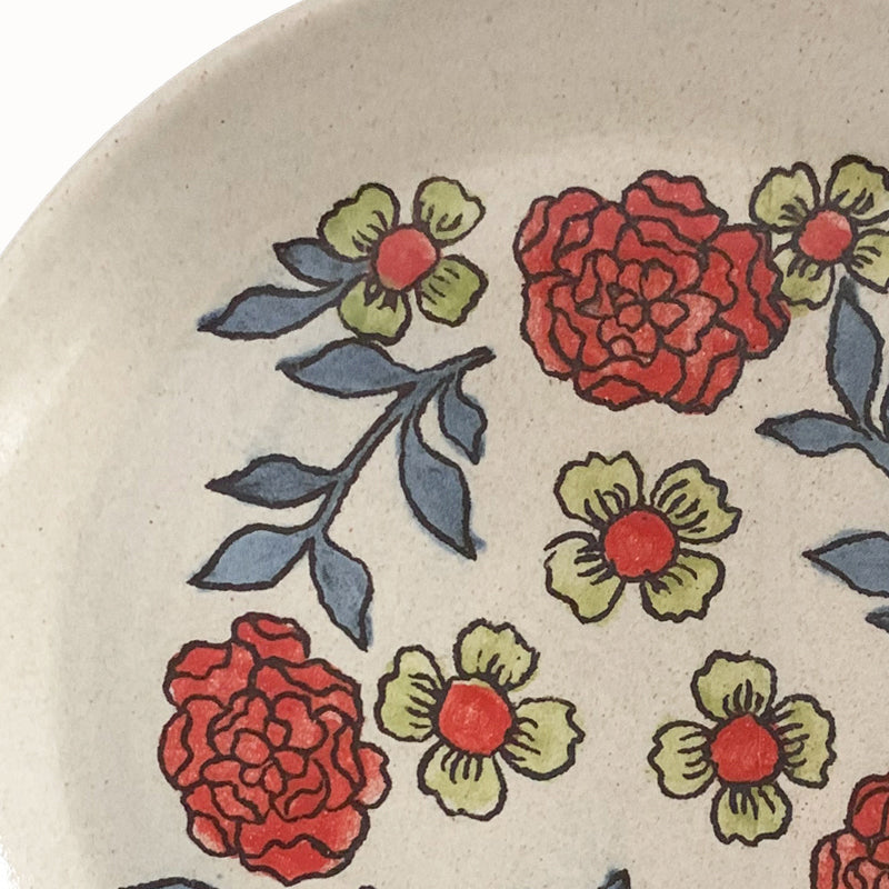 Handmade pottery from Off Menu Pots. Dessert plate with red and charteuse flowers. Detail.
