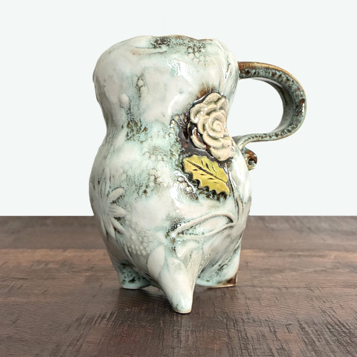 Handmade ceramic mug, cream with floral details. Made by Paula Smith.