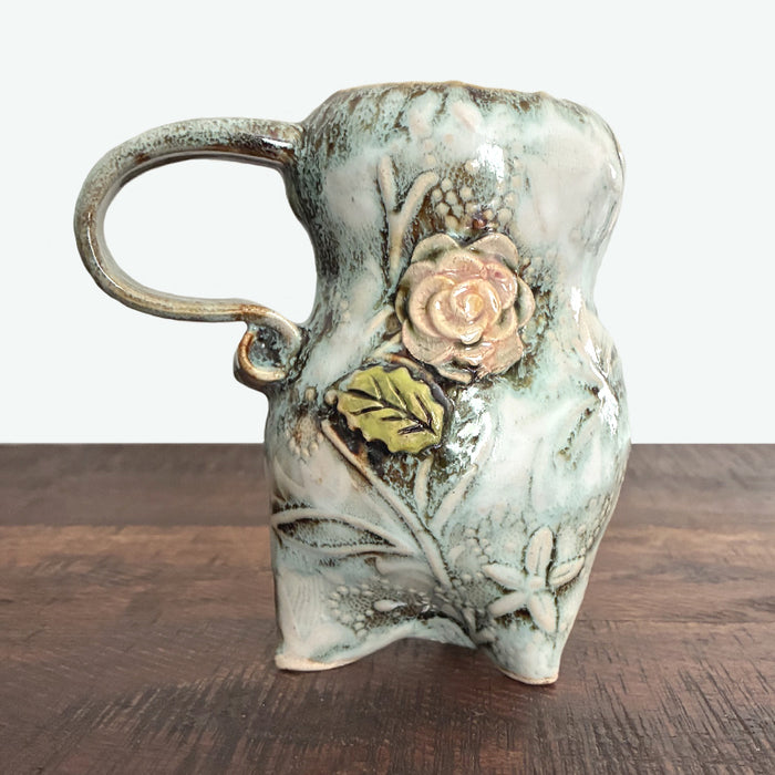 Handmade ceramic mug, cream with floral details. 