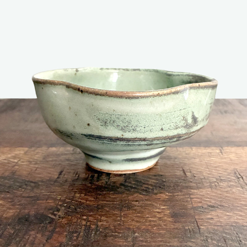 Small handmade, fluted snack bowl by Paula Smith. Pale, muted green with rustic details. 