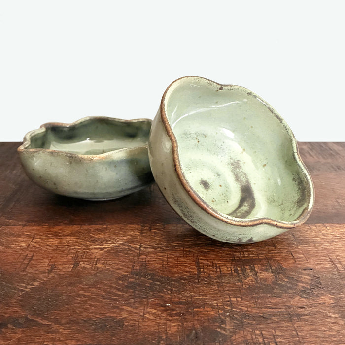Small handmade, fluted snack bowls by Paula Smith. Pale, muted green with rustic details. 