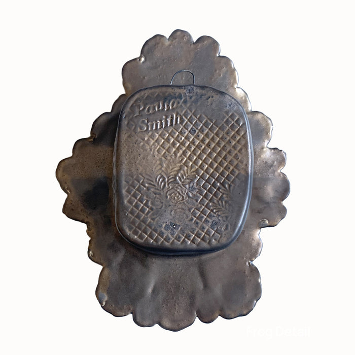 Frog 1 ceramic wall niche by Paula Smith. Decorative wall art featuring a frog and flowers. Back view.