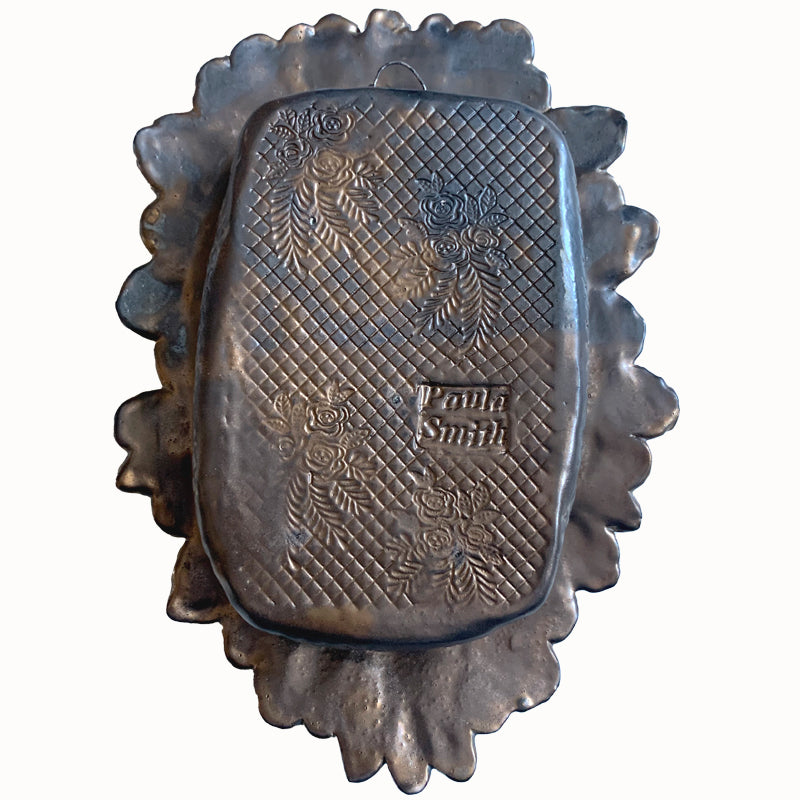 Hand and Hearts ceramic wall niche by Paula Smith. Decorative wall art featuring a hand, hearts and flowers. Back view. 