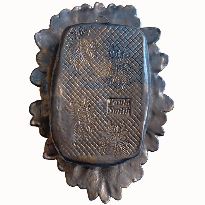 Hand and Hearts ceramic wall niche by Paula Smith. Decorative wall art featuring a hand, hearts and flowers. Back view. 