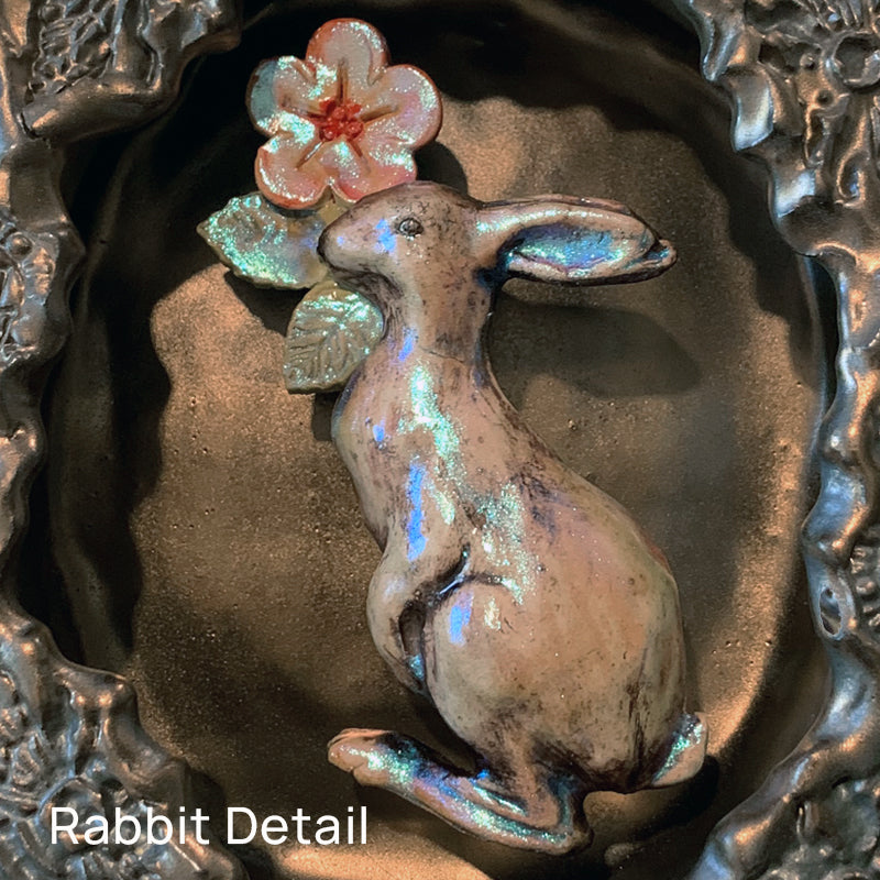 Rabbit and snail ceramic wall niche by Paula Smith. Decorative wall art featuring a rabbit, snail and flowers. Detail of rabbit shown.