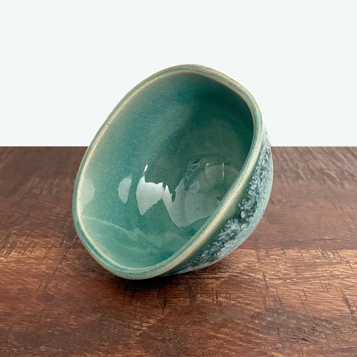 Small squared aqua green ceramic bowl, interior view, handmade by Paula Smith. 