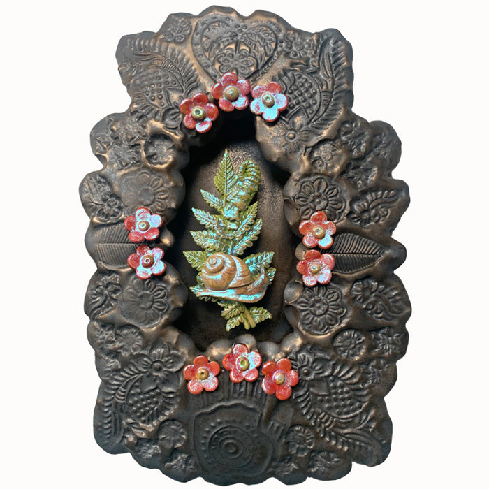 Snail ceramic wall niche by Paula Smith. Decorative wall art featuring a snail, fern and flowers. 