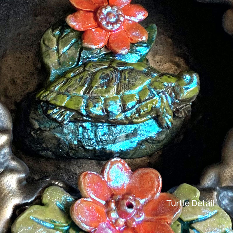 Turtle ceramic wall niche by Paula Smith. Decorative wall art featuring a turtle and flowers. Turtle detail.