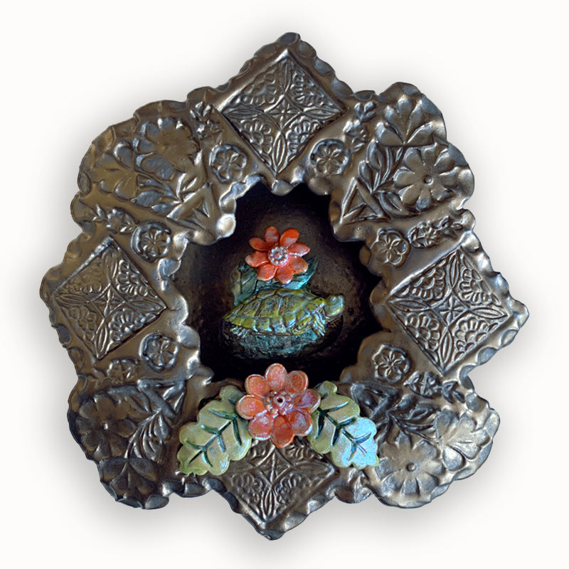 Turtle ceramic wall niche by Paula Smith. Decorative wall art featuring a turtle and flowers. 