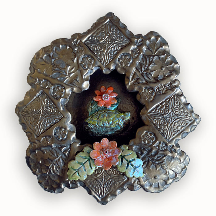 Turtle ceramic wall niche by Paula Smith. Decorative wall art featuring a turtle and flowers. 