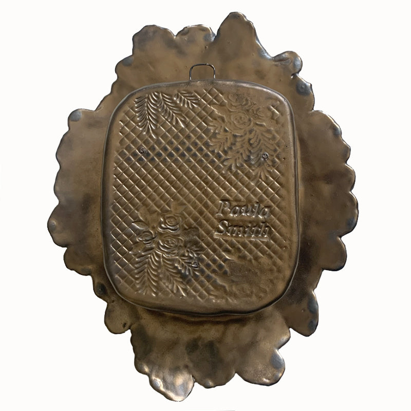 Handmade ceramic wall niche with flower details by Paula Smith. Gunmetal glazed clay with stamped details, with three dimensional yellow flowers and leaves. Back view.