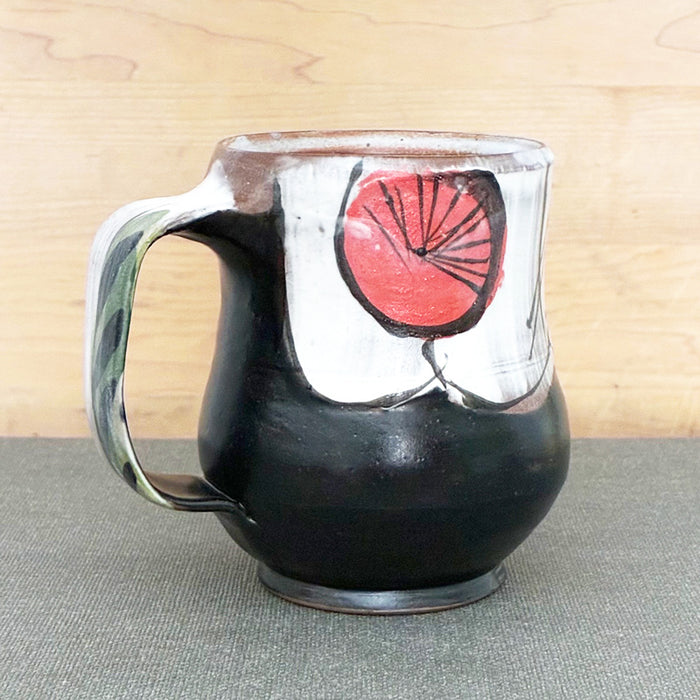 Handmade ceramic mug, black and white with abstracted red floral design by Renata Copeland. Alternate view.