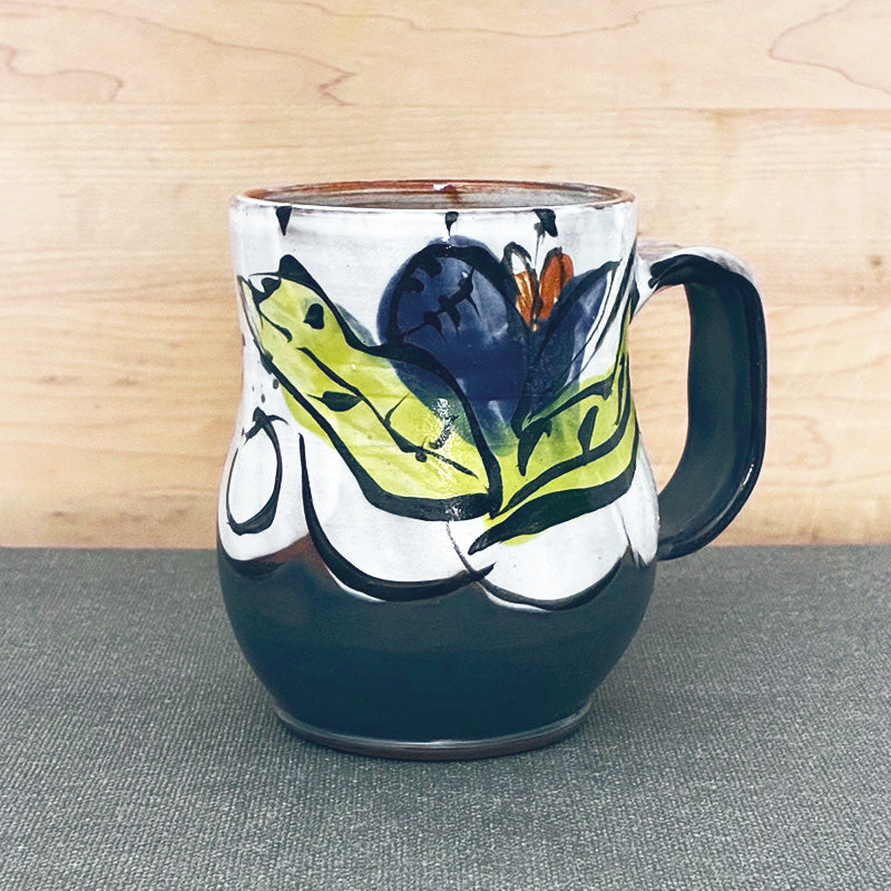 Handmade ceramic mug, blue and white with blue floral design and chartreuse leaves by Renata Copeland. 