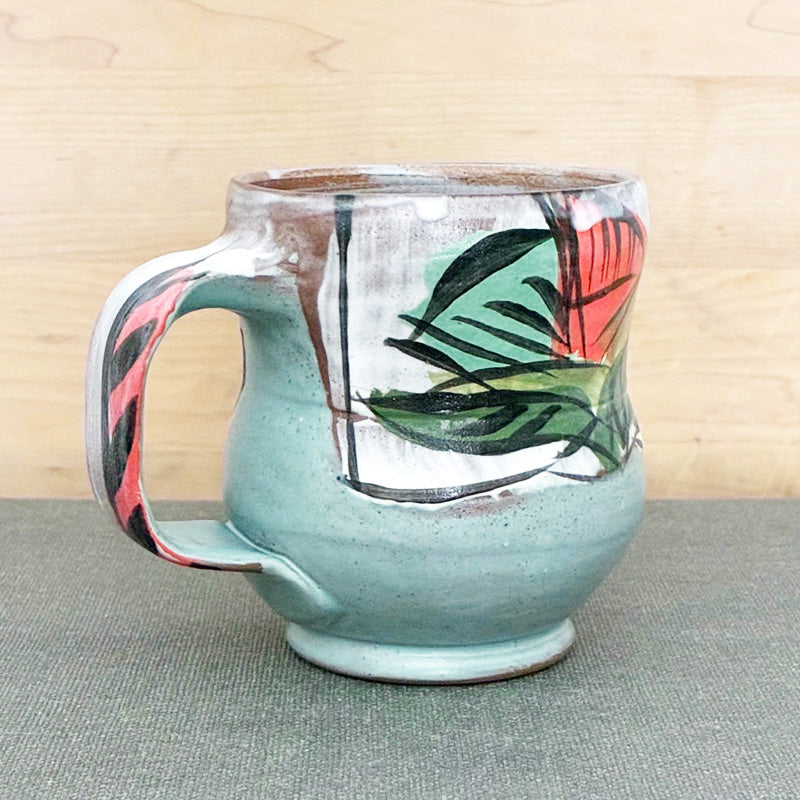 Handmade ceramic mug, yellow and white with bold orange and aqua floral design by Renata Copeland. 