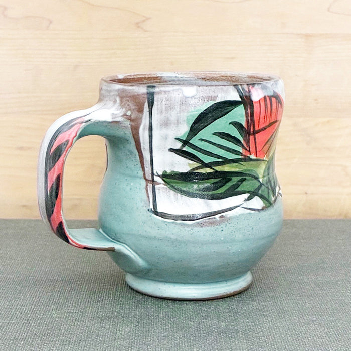 Handmade ceramic mug, yellow and white with bold orange and aqua floral design by Renata Copeland. 