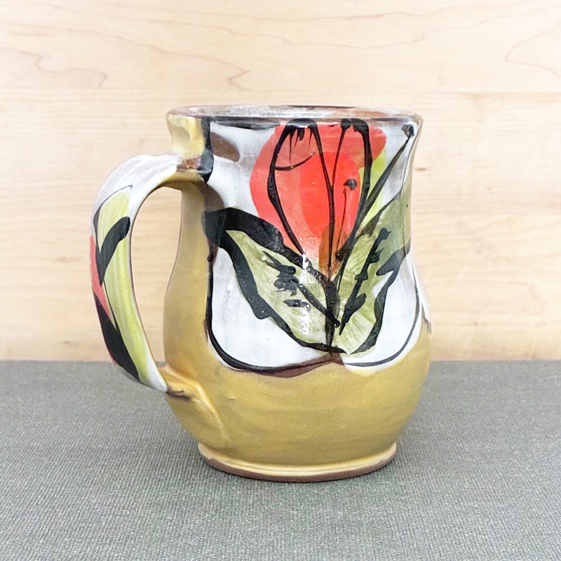 Handmade ceramic mug, yellow and white with bright orange floral design by Renata Copeland. Alternate view.