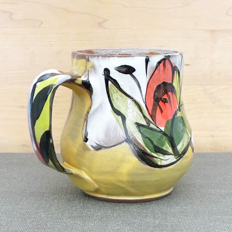Handmade ceramic stoneware mug, yellow and white with orange floral design by Renata Copeland. 