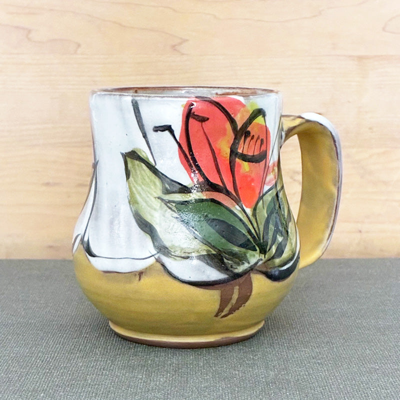 Handmade ceramic stoneware mug, yellow and white with orange floral design by Renata Copeland. 