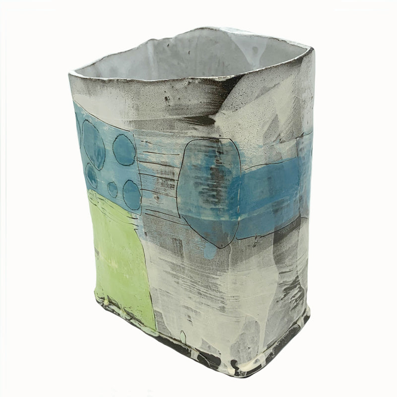 Box vase by ceramic artist Robin Ralston Frelier. Large box vase with graphic blue and green details and various textures. Angled back view.