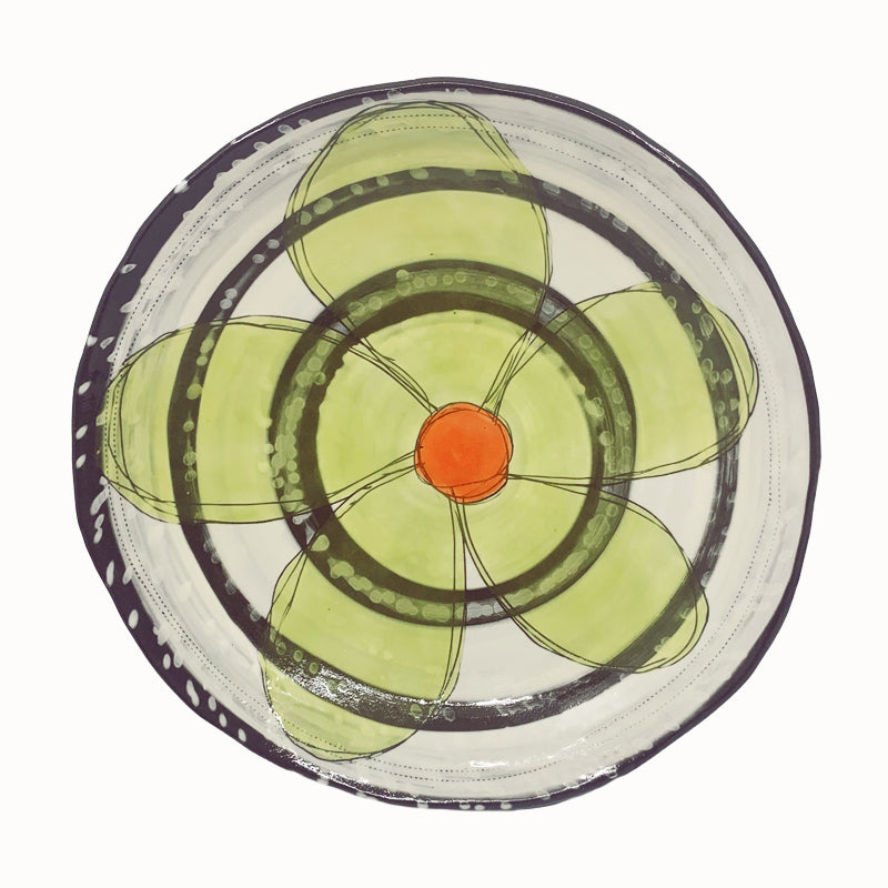 Medium shallow serving bowl with flower and circle decoration by ceramic artist Robin Ralston Frelier. Bowl features a yellow green flower with orange center.