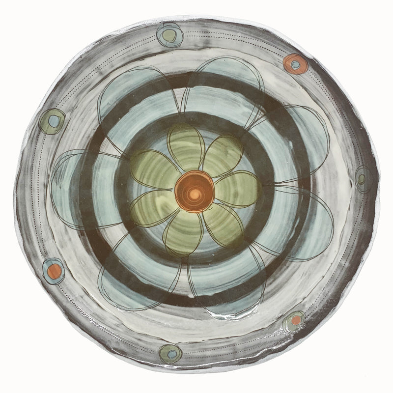 Large shallow serving bowl with flower and circle decoration by ceramic artist Robin Ralston Frelier. Bowl features a light blue and pale green flower with rusty orange accents.