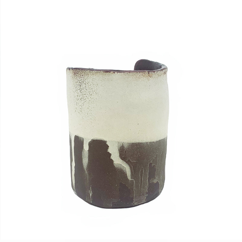 Small dark brown and white drippy vase by ceramic artist Robin Ralston Frelier. Back view.