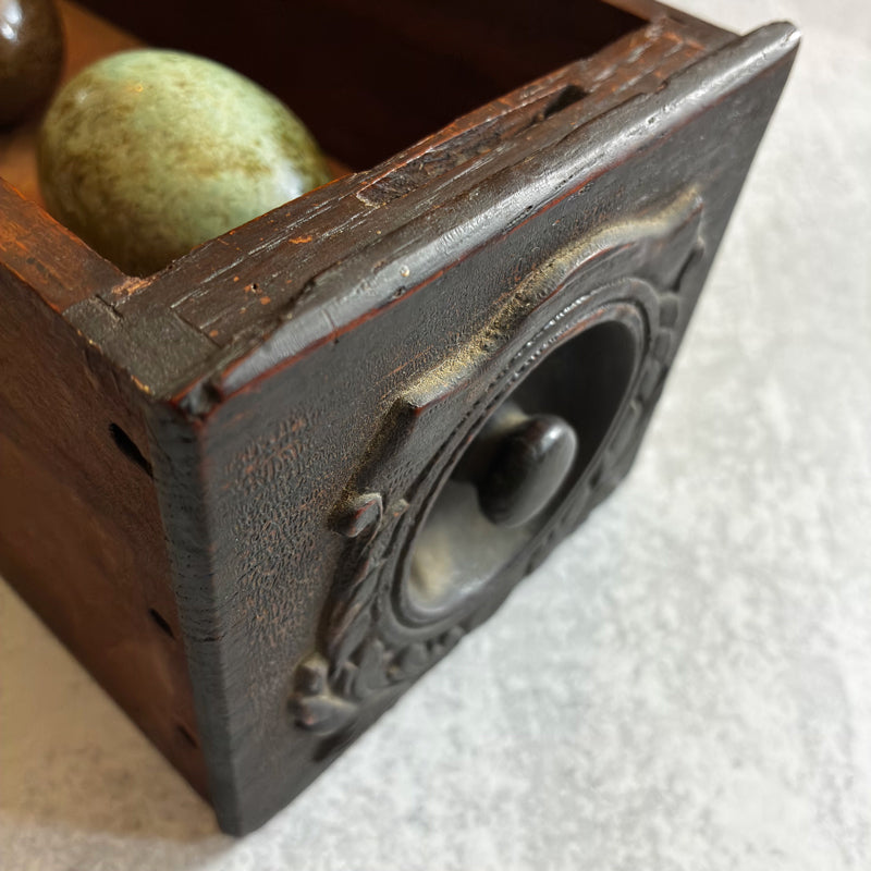 Three handmade ceramic eggs and handmade, tea stained papers set in a small vintage wood drawer. Avian Archives artwork series by Sarah Treanor. Drawer detail.