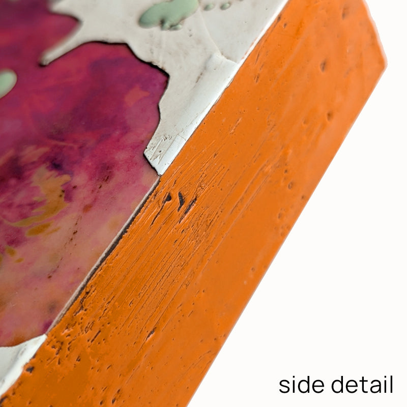 Bloom No. 11, small mixed media painting by artist Sarah Treanor. Fuchsia and orange textural, floral artwork created with digital prints of the  artist's cyanotypes and eco prints underneath layers of encaustic paint, with splatters of light green encaustic on top. Side detail shown.