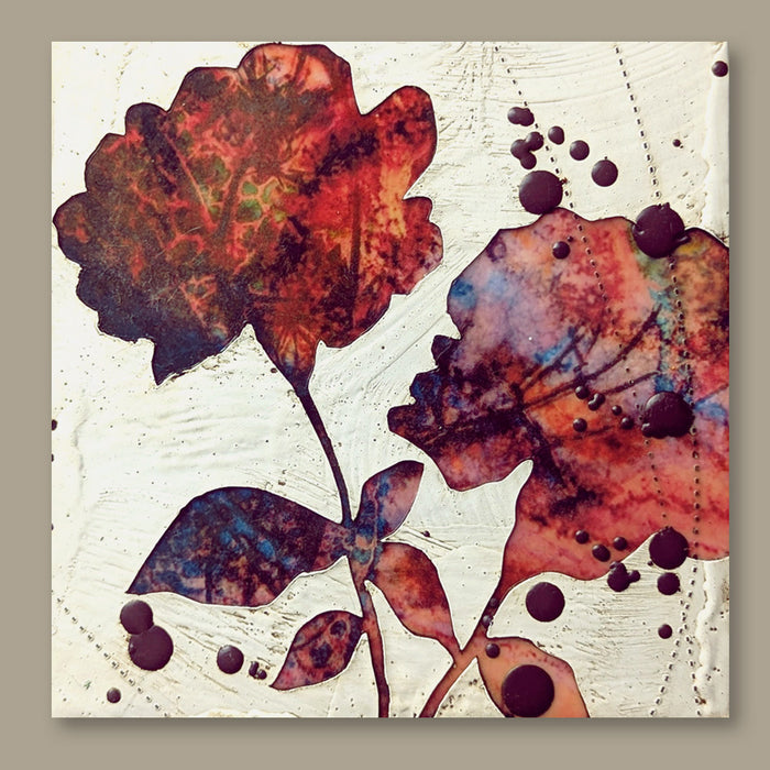 Bloom No. 13, small mixed media painting by artist Sarah Treanor. Red and purple textural, floral artwork created with digital prints of the  artist's cyanotypes and eco prints underneath layers of encaustic paint, with splatters of purple encaustic on top. Shown on tan wall.