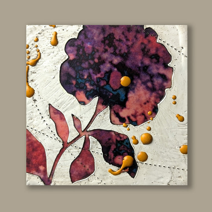 Bloom No. 16, small mixed media painting by artist Sarah Treanor. Red and purple textural, floral artwork created with digital prints of the  artist's cyanotypes and eco prints underneath layers of encaustic paint, with splatters of orange encaustic on top. Shown on tan wall.