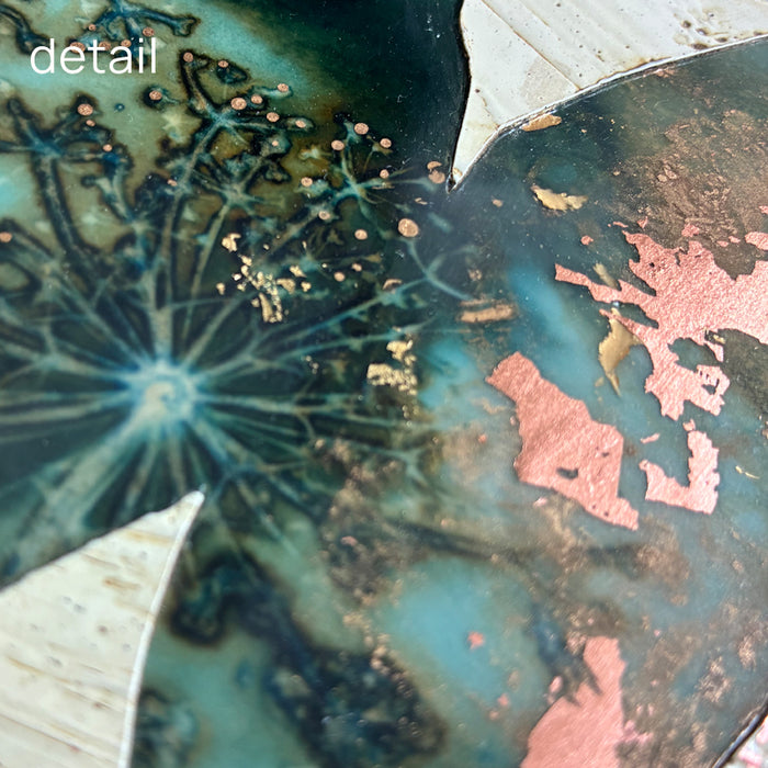 Midnight Embers I mixed media encaustic leaf artwork in rich blues with gold and copper leaf details. Close up view.