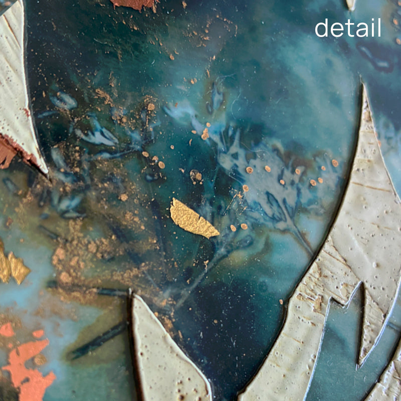 Midnight Embers III mixed media encaustic leaf artwork in rich blues with gold and copper leaf details. Close up view.