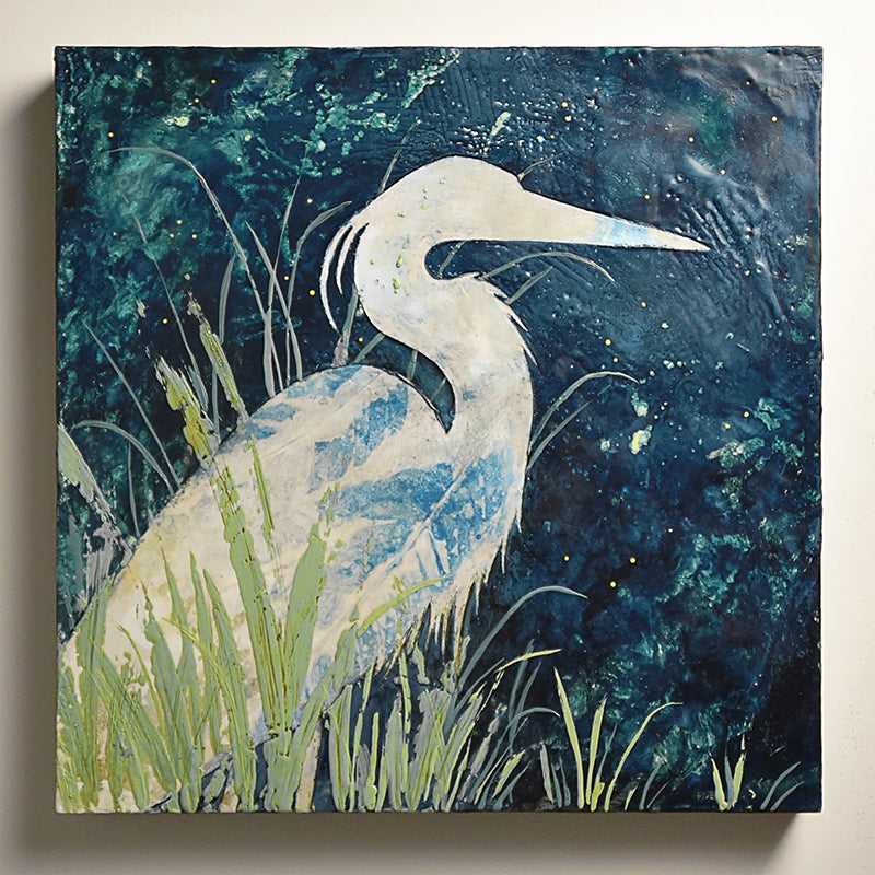 A white heron sitting among green leaves under a dark blue sky. Encaustic and eco print artwork by Sarah Treanor at Lark & Key, Charlotte NC. 