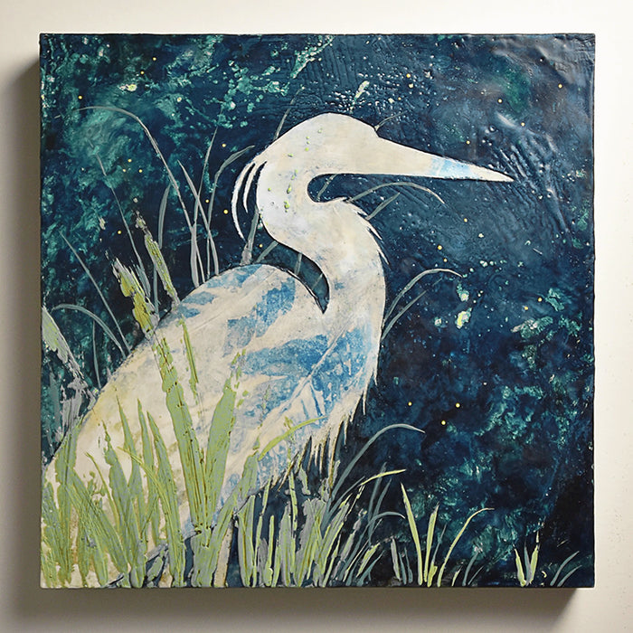 A white heron sitting among green leaves under a dark blue sky. Encaustic and eco print artwork by Sarah Treanor at Lark & Key, Charlotte NC. 