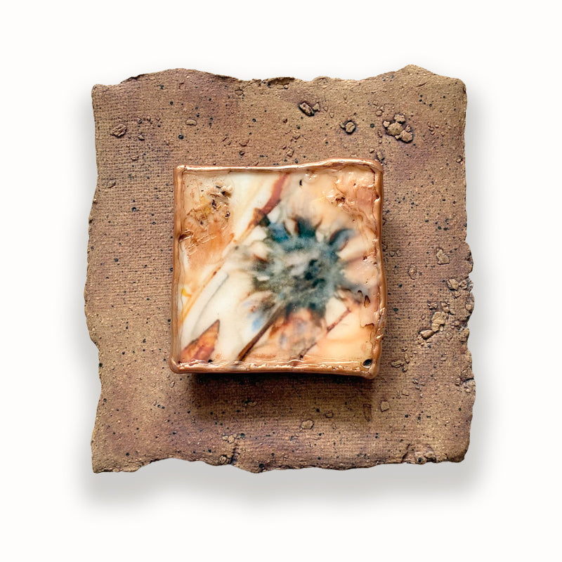 Textured and irregular shaped ceramic tile with mixed media flower design in the center. Artwork by Sarah Treanor. 