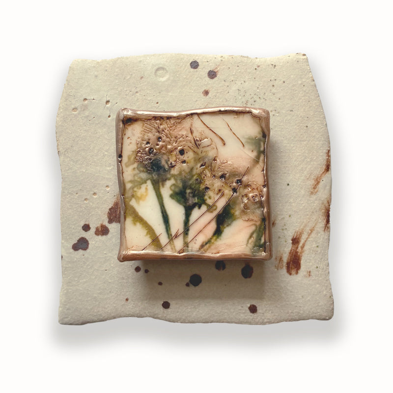Small ceramic tile with mixed media flower center. Artwork by Sarah Treanor. 