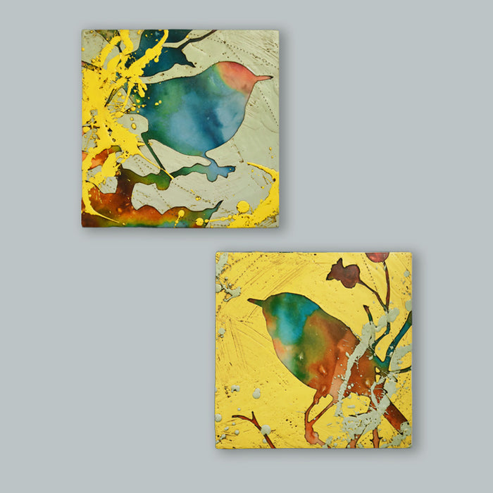 Two colorful, abstracted, textural bird and foliage mixed media paintings by artist Sarah Treanor. Shown on pale blue wall. 