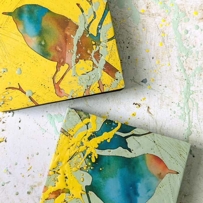 Colorful, abstracted, textural bird and foliage artwork by artist Sarah Treanor. Shown on a paint splattered background.