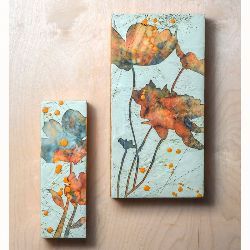 Two mixed media encaustic flower themed paintings by artist Sarah Treanor. Aqua blue and orange colorway. 