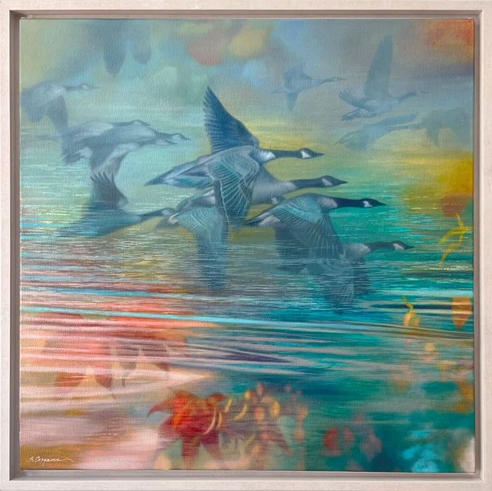 Oil painting with geese flying over reflective water in soft pastel tones of blue, teal, green, yellow, and orange. The artwork, by Sharon Cosgrove, is set in a hardwood maple frame. 