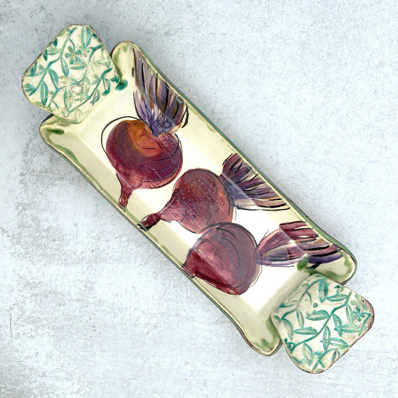 Small handmade serving tray by Molly Lithgo with beet decoration.