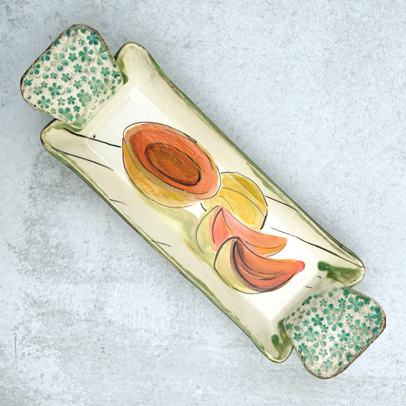 Small handmade serving tray by Molly Lithgo with cantaloupe decoration.