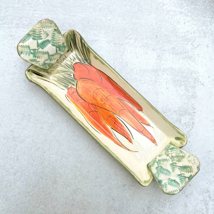 Small handmade ceramic serving tray by Molly Lithgo decorated with a bunch of carrots. 